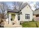 Charming home with fresh lawn, bright green door, and black trim windows at 1102 N Newman St, Indianapolis, IN 46201
