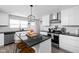 Updated kitchen with white cabinets, black countertops, island, and stainless steel appliances at 1102 N Newman St, Indianapolis, IN 46201