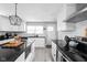 Spacious kitchen featuring an island, white cabinets, modern appliances, and backsplash at 1102 N Newman St, Indianapolis, IN 46201