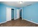 Bedroom with light blue walls, wood flooring, and a closet at 1130 W 33Rd St, Indianapolis, IN 46208