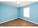 Bright bedroom featuring light blue walls and wood flooring at 1130 W 33Rd St, Indianapolis, IN 46208