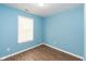 Spacious bedroom with light blue walls and wood-look flooring at 1130 W 33Rd St, Indianapolis, IN 46208