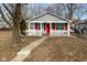 Gray house with red door and porch, steps leading to the entrance at 1130 W 33Rd St, Indianapolis, IN 46208