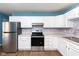 White kitchen cabinets and stainless steel appliances at 1130 W 33Rd St, Indianapolis, IN 46208