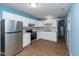 White kitchen cabinets, stainless steel appliances, and wood floor at 1130 W 33Rd St, Indianapolis, IN 46208