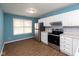 Modern kitchen with stainless steel appliances and light blue walls at 1130 W 33Rd St, Indianapolis, IN 46208