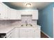 White cabinets, marble countertops, and a stylish sink at 1130 W 33Rd St, Indianapolis, IN 46208