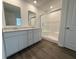 Contemporary bathroom features double vanity, modern mirrors, glass shower, and hardwood flooring at 116 Marble Wood Dr, Danville, IN 46122