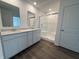 Modern bathroom featuring dual sinks, quartz countertops, white cabinets, and a glass-enclosed shower at 116 Marble Wood Dr, Danville, IN 46122