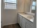 Bathroom features a double sink vanity with quartz countertops, wood-look floors, and natural light at 116 Marble Wood Dr, Danville, IN 46122