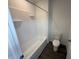 Modern bathroom features a white tub and shower combination, sleek fixtures, and wood look floors at 116 Marble Wood Dr, Danville, IN 46122