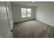 Well-lit bedroom boasts soft carpeting, a large window offering neighborhood views, and a closet at 116 Marble Wood Dr, Danville, IN 46122