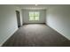 Spacious bedroom featuring neutral carpet, ample natural light from a large window, and fresh, white walls at 116 Marble Wood Dr, Danville, IN 46122