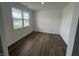 Bright, modern bedroom with hardwood floors and a large window providing ample natural light at 116 Marble Wood Dr, Danville, IN 46122