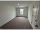 Bright bedroom with soft carpeting, a window offering views of the neighborhood, and a convenient closet at 116 Marble Wood Dr, Danville, IN 46122