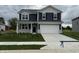 Charming two-story home featuring blue siding, a gray brick facade, and a well-maintained lawn at 116 Marble Wood Dr, Danville, IN 46122