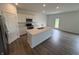 Modern kitchen with white cabinets, stainless steel appliances, and a large island with a sink at 116 Marble Wood Dr, Danville, IN 46122