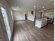 Expansive living space featuring an open layout that connects to the kitchen and an exterior door at 116 Marble Wood Dr, Danville, IN 46122