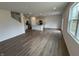 Open-concept living area featuring modern flooring, recessed lighting, and seamless transition to the kitchen at 116 Marble Wood Dr, Danville, IN 46122