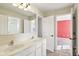 Bright bathroom with double sink vanity and a view through doorways of an adjacent bedroom at 14928 Declaration Dr, Westfield, IN 46074