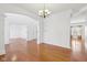 Formal dining room featuring hardwood floors, chandelier lighting, neutral colors, and an open layout at 14928 Declaration Dr, Westfield, IN 46074