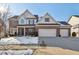 Charming two-story home featuring a brick and siding facade, a three-car garage, and a welcoming front porch at 14928 Declaration Dr, Westfield, IN 46074