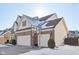 View of the 3 car garage showcasing a brick facade, basketball hoop, and well-maintained landscaping at 14928 Declaration Dr, Westfield, IN 46074