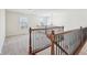 Upstairs hallway featuring wood and wrought iron railing, carpet, and a window bringing in natural light at 14928 Declaration Dr, Westfield, IN 46074