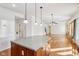 Kitchen with island, stainless appliances and open floor plan leading to the living room at 14928 Declaration Dr, Westfield, IN 46074