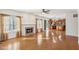 Spacious living room featuring hardwood floors, a fireplace, large windows, and seamless flow into the kitchen at 14928 Declaration Dr, Westfield, IN 46074