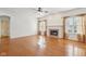 Bright living room with hardwood floors, a fireplace, large windows, and neutral color palette at 14928 Declaration Dr, Westfield, IN 46074