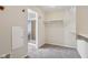 Bright walk-in closet with gray carpet and white shelving, plus a shower room in the background at 14928 Declaration Dr, Westfield, IN 46074