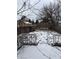 Snowy backyard with a deck and bare trees at 239 Iowa St, Indianapolis, IN 46225