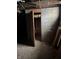 Unfinished basement with open door and debris at 239 Iowa St, Indianapolis, IN 46225