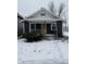 Cute bungalow with blue siding, white trim, and a yellow door at 239 Iowa St, Indianapolis, IN 46225