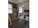Damaged kitchen with exposed walls and doorway to another room at 239 Iowa St, Indianapolis, IN 46225