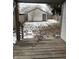 Wooden deck overlooks backyard with detached garage and snowy ground at 243 E Caven St, Indianapolis, IN 46225
