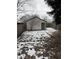 White detached garage with grey trim in backyard; snowy ground at 243 E Caven St, Indianapolis, IN 46225
