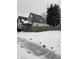 Snow covered lawn and charming craftsman style home with yellow door at 243 E Caven St, Indianapolis, IN 46225