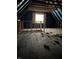 Unfinished attic featuring wooden framing and a window at 243 E Caven St, Indianapolis, IN 46225