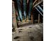 Unfinished attic space with wooden beams and flooring at 243 E Caven St, Indianapolis, IN 46225