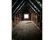 Unfinished attic area with window, offering potential for expansion at 243 E Caven St, Indianapolis, IN 46225