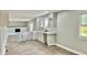Renovated kitchen featuring white cabinets, subway tile, and hardwood floors at 5619 Pappas Dr, Indianapolis, IN 46237
