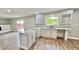 Renovated kitchen featuring white cabinets, subway tile, and hardwood floors at 5619 Pappas Dr, Indianapolis, IN 46237