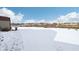Snowy backyard with shed and view of construction at 6350 W Chelmsford Dr, McCordsville, IN 46055
