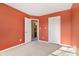 Bedroom with orange walls, carpet, and access to bath and closet at 6350 W Chelmsford Dr, McCordsville, IN 46055