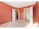 Bedroom with orange walls, carpet, and access to bath and closet at 6350 W Chelmsford Dr, McCordsville, IN 46055