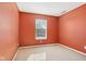 Spacious bedroom with orange walls and carpet flooring at 6350 W Chelmsford Dr, McCordsville, IN 46055