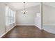 Bright dining room features hardwood floors and a chandelier at 6350 W Chelmsford Dr, McCordsville, IN 46055