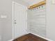 Front entry with white door and a rustic wood accent wall at 6350 W Chelmsford Dr, McCordsville, IN 46055